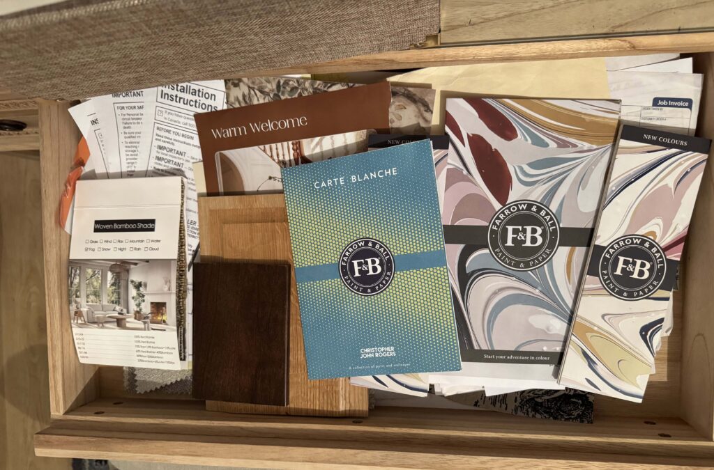 paint color and wallpaper samples in a drawer